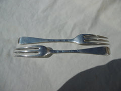 1721 fine pair of George 1st Britannia standard three pronged forks with crest and motto