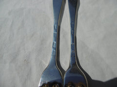 1721 fine pair of George 1st Britannia standard three pronged forks with crest and motto
