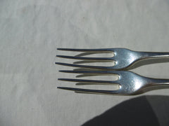 1721 fine pair of George 1st Britannia standard three pronged forks with crest and motto